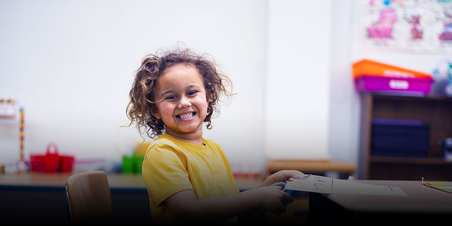 Smiling student in a classroom.