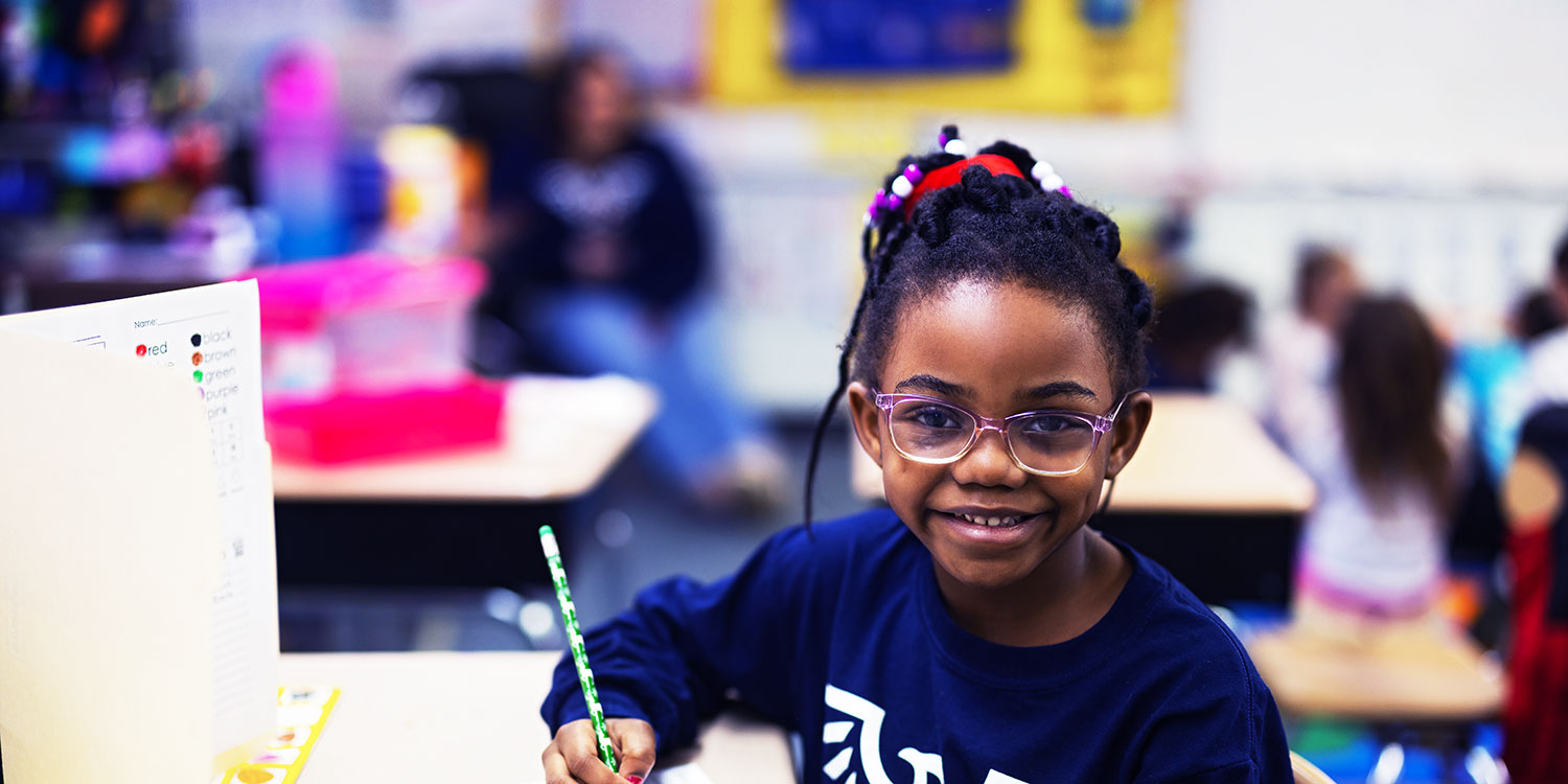 Smiling student in a classroom.