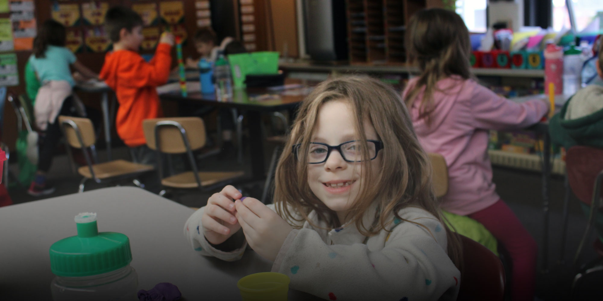 Student using Playdoh at desk